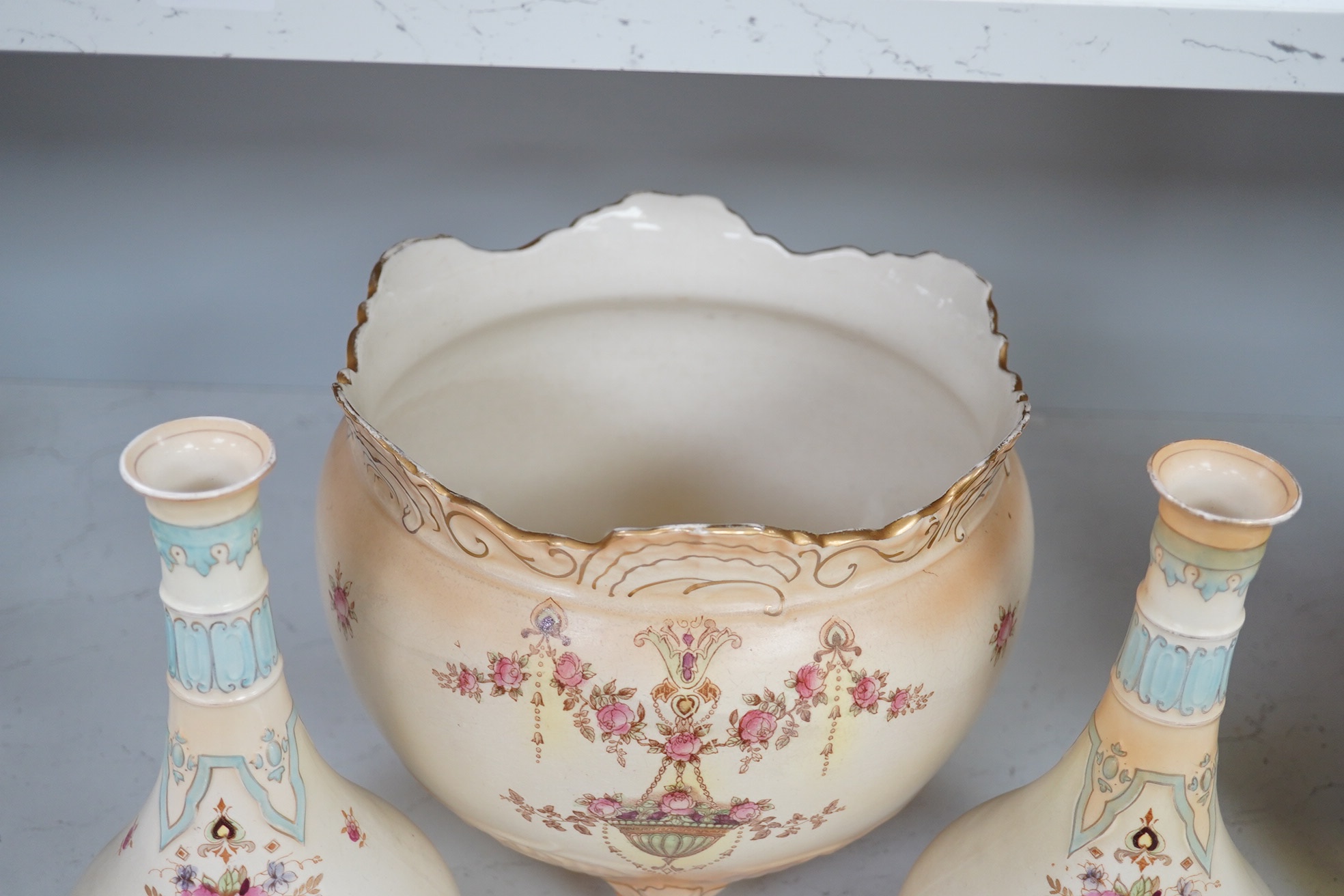 A Crown Devon jardiniere, 23cm high, and a pair of vases, 25.5cm high. Condition - fair to good